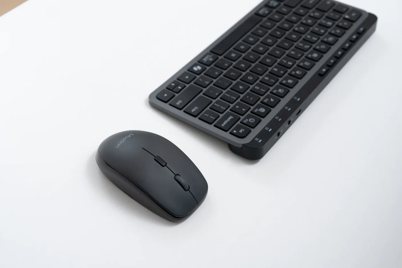 Meetion BTM100 mouse and keyboard on a bright desk